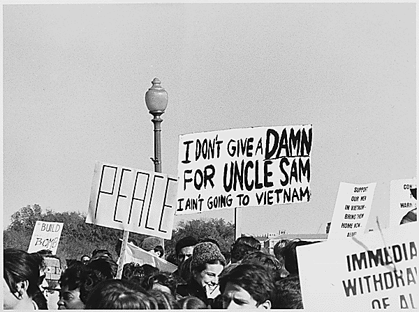 Antiwar signs are held by people in a crowd