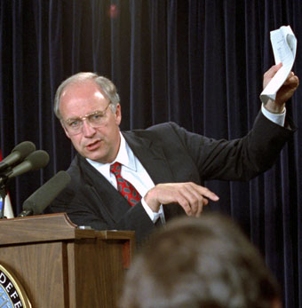 Dick Cheney holding up a piece of paper at a press conference