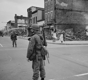 Destroyed building with soldier in foreground
