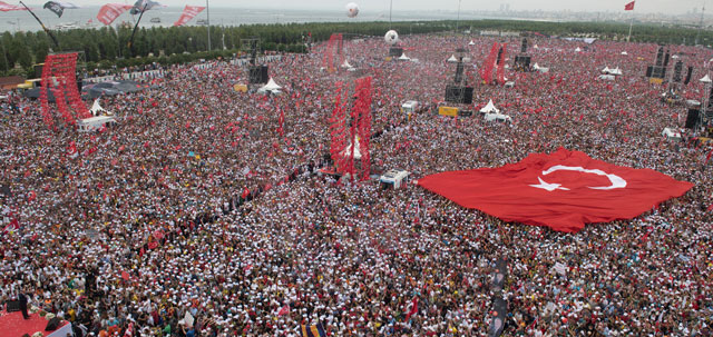 Crowd of people with giant Turkish flag