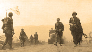 Soldiers in Vietnam walking on road