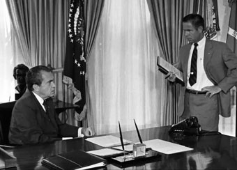 Richard Nixon (sitting) with H. R Haldeman (standing)
