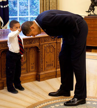 A boy feels President Barack Obama's head