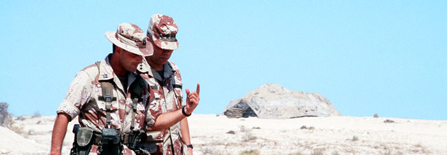 Colin Powell walking in Saudi Arabian desert with a fellow soldier