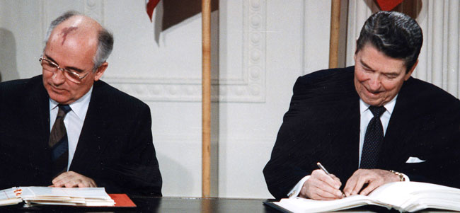 Ronald Reagan and Mikhail Gorbachev signing treaty