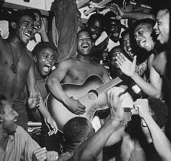 Enlisted men aboard the U.S.S. Ticonderoga hear the news of Japan's surrender