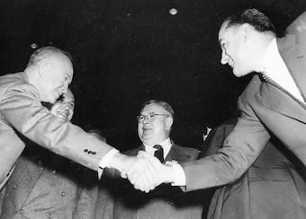 Dwight Eisenhower fails to avoid Joseph McCarthy's handshake on the campaign trail.