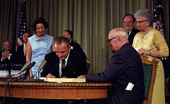 President Johnson signing Medicare with President and Bess Truman