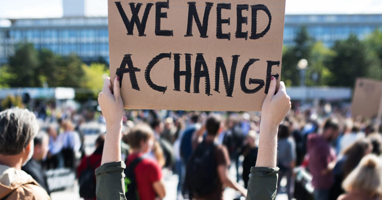 Protest for change, woman holding a sign