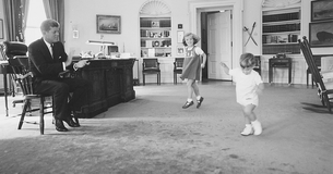 President John F. Kennedy with his kids in the Oval Office.