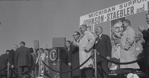 President Johnson on stage with a group at a campaign rally