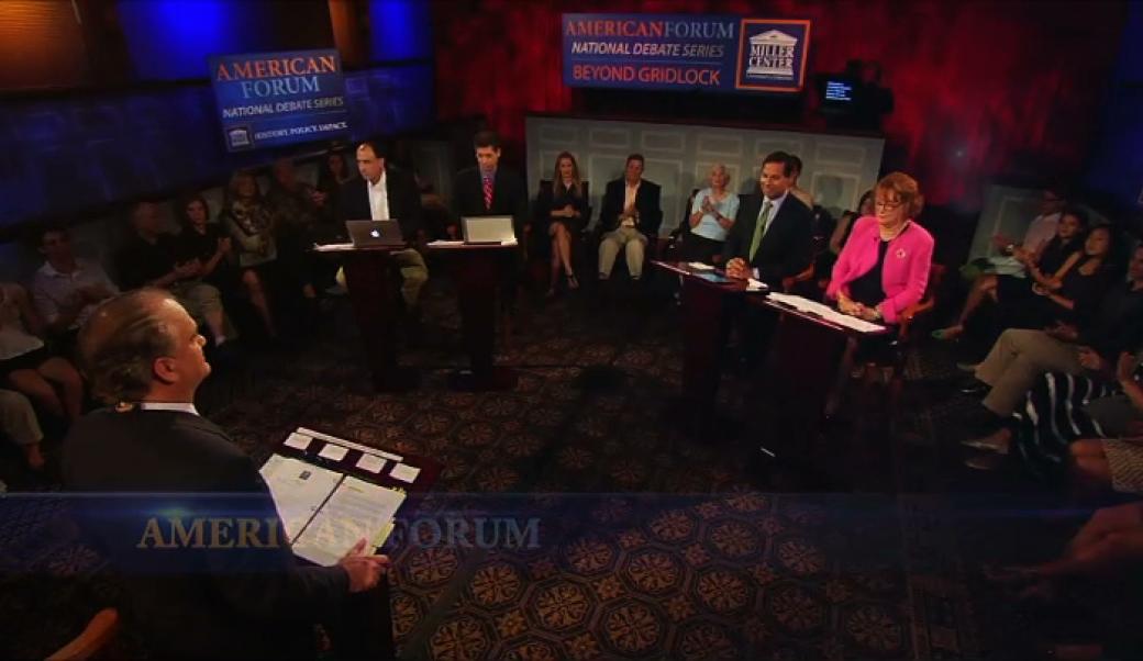Presenter and panelists gathered in a room