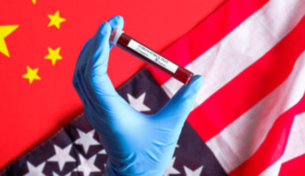 Chinese-US flags with test tube in gloved hand