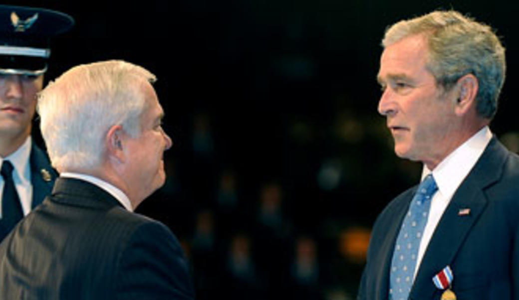 Robert Gates shaking hands with George Bush