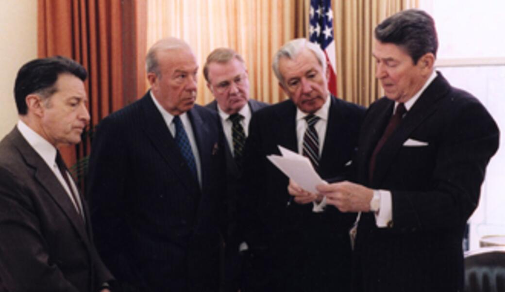 President Ronald Reagan talks with his advisors