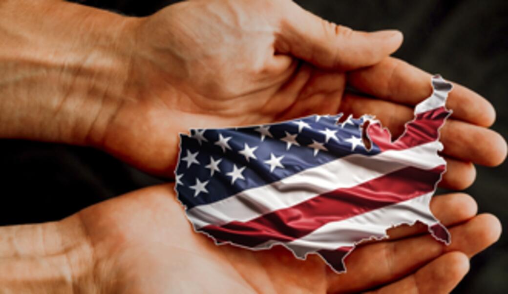 image of hands holding map of united states with flagf superimposed