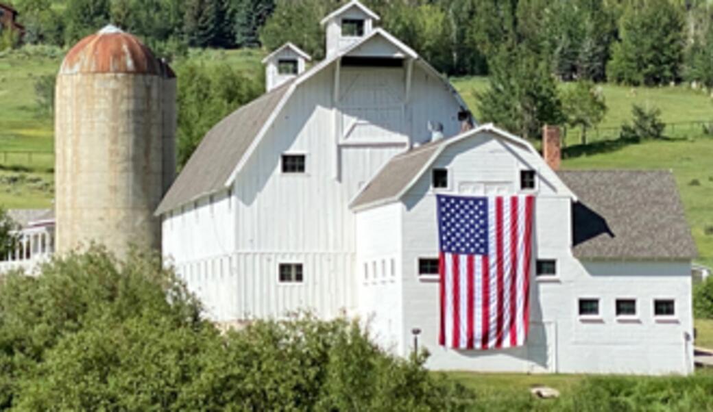 white barn with huge American flag