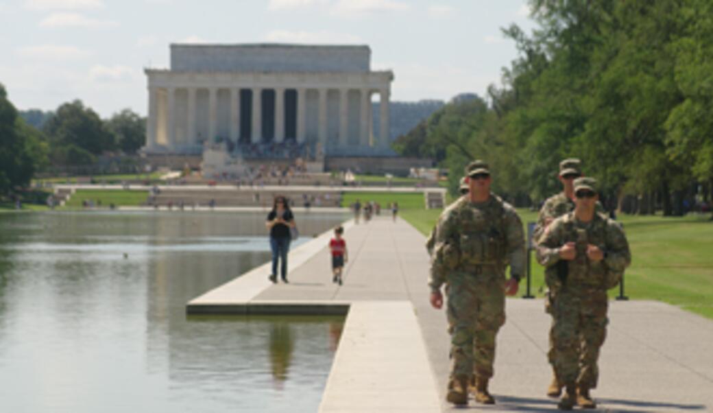 National Guard troops walking along  the reflecting pool on National Mall in Dc, August 2025