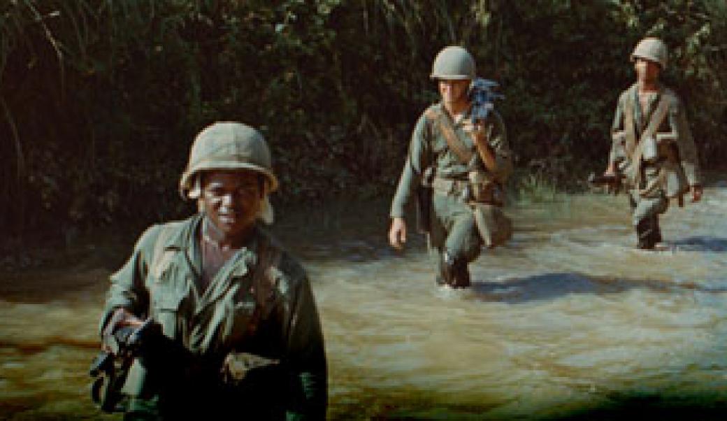Soldiers walking through a river in Vietnam