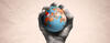 hand holding a ball with globe illustration