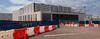Sterling, Virginia, USA – September 5, 2026: Cranes and construction barriers surround a data center under construction.