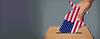 image of a hand putting a US map into a ballot box