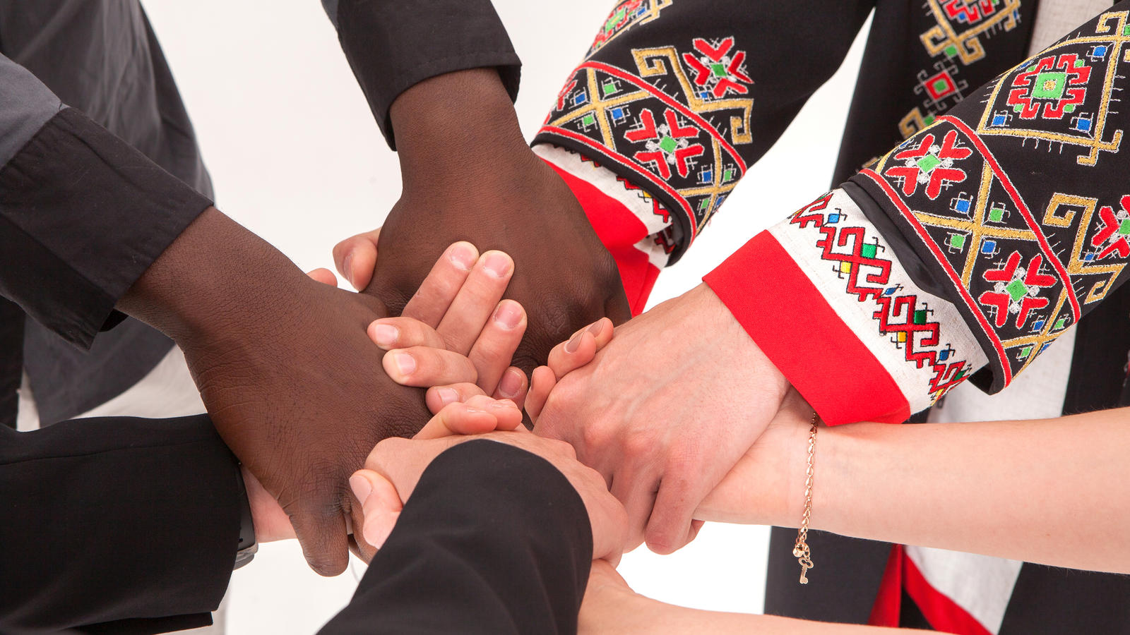 hands of many colors holding each other